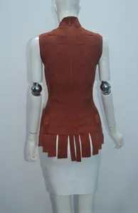 Detail view of brick red knit vest featuring textured grid weave and fringe hem details