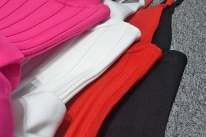 Macro view of multi-color ribbed bandage fabric in red, white, pink and black