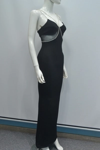 Dettaglio dell'abito da sera nero slim con spalline in catena di diamanti e inserti in tulle