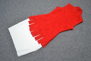Detail of red and white bandage set featuring textured weave and fringe trim design