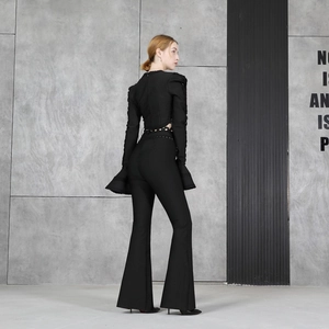 Women's black 2-piece set featuring cutout long sleeve ruffle top and high waist flared pants