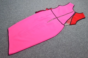 Detail of elegant color-block sleeveless dress featuring back gold zipper and slim fit