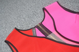 Detail of metal zipper and mesh splicing on red and pink bandage dress bodice