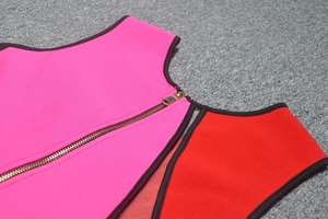 Detail of color-block bandage dress with gold zipper and contrast mesh paneling