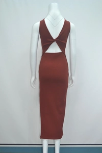 Detail view of the rust red ribbed knit dress featuring a deep V back with twist knot detail