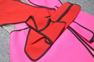 Detail of pink and red bodycon dress featuring mesh panels and 3D bow decoration