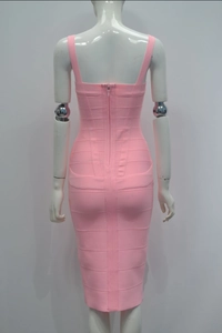 Detail view of the back of a pink bandage midi dress featuring a hidden zipper and fitted cut