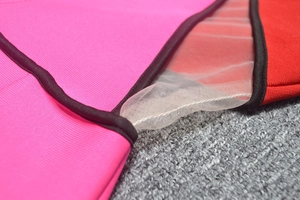 Detail of color block sleeveless dress showing mesh splicing and precision stitching