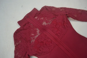 Détail de l'encolure en dentelle florale et de la fermeture éclair sur une robe bordeaux