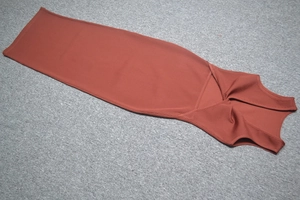 Close-up of brick red sleeveless midi dress featuring ribbed knit texture and hollow-out detail