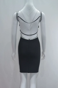 Close-up of sexy open back black mini dress with silver rhinestone trim and straps