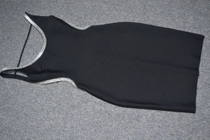 Detail of black mini bandage dress featuring silver rhinestone trim on cutout sections