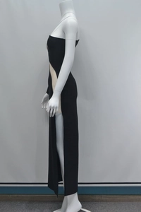Detail view of black cut-out bandage dress featuring high slit and elastic knit fabric
