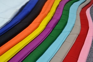 Texture detail of heavy stretch bandage dress fabric in eleven vibrant assorted colors