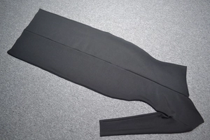 Detailed flat lay of black bodycon bandage maxi dress with cutout mesh and high slit
