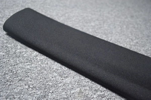 Macro detail of high-quality black knitted fabric texture on an ergonomic support cushion