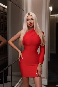 Close-up of red one-shoulder long sleeve dress with slim fit asymmetric design