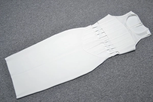 Detail of white mesh bandage dress featuring side cutout stripes and bodycon silhouette