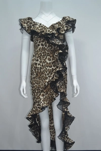 Detail of ruffle trim and leopard print fabric on an off-shoulder high-low hem dress