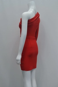Close-up of the red one-shoulder bandage dress showing pleats and slim fit silhouette