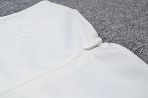 Close-up of white mesh bandage dress featuring high-quality invisible zipper and knit texture