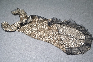 Detail of leopard print midi dress featuring elegant black sheer mesh ruffled hemline