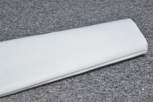 Close-up of white bandage dress fabric showing premium twill weave and neat stitching detail