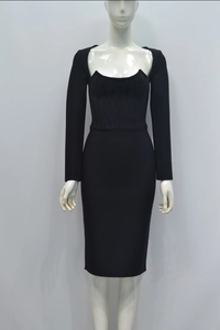 Close-up of black midi dress with deep U-neckline and textured corset-style waist detail