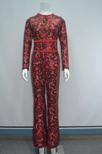 Close-up of red lace jumpsuit featuring intricate sequins and woven waist belt detailing