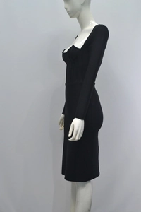 Detail view of the elegant corset-style bustier and pleated waist of the black pencil dress