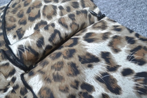 Close-up of high-quality black invisible zipper on leopard print sleeveless midi dress