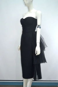 Detail of elegant black tube bodycon dress with layered side mesh ruffles and sleek finish