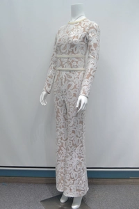 Detailed view of white lace jumpsuit featuring sequin embellishments and pearl beaded waistline