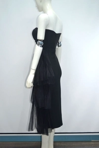 Detail view of the layered black mesh ruffles on the side of a bodycon tube dress