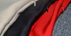 Detailed close-up of high-quality invisible zippers on textured bandage dress fabrics