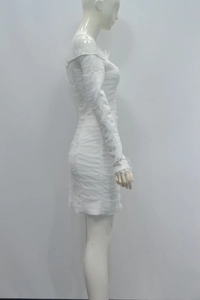 Detail view of the elegant pleated mesh texture on white off-shoulder bandage dress