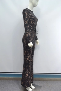 Detailed close-up of intricate black lace fabric with sparkling sequins and skin-tone lining
