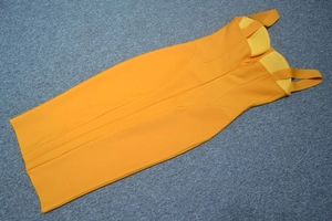 Detail of orange bandage dress showing thick elastic fabric texture and padded cups