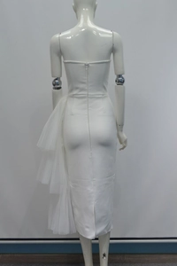 Detail view of the back zipper and mesh ruffles on white strapless bandage dress