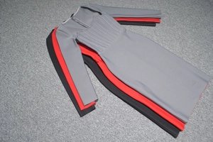 Detail of slim fit mini dresses featuring U-neckline and radial pleated chest design