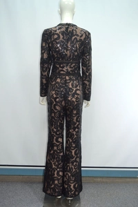 Detail of black lace jumpsuit featuring sparkling sequins and wide-leg trousers