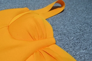 Detail view of ribbed orange bodycon dress with structured cups and wide straps