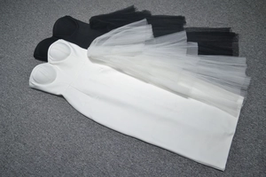 Detail of sweetheart neckline and side mesh ruffle on black and white bandage dresses