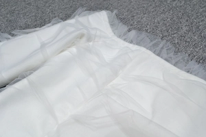 Elegant white mesh off-shoulder bandage dress featuring ruffled layers and tiered lace design