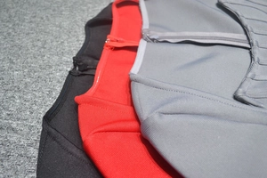Detail of ribbed knit texture and invisible zipper on pencil dress in black red and gray