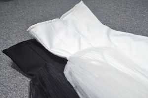 Detail of slim fit strapless dress with ribbed bodice and tiered mesh tulle skirt