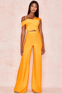 Detail view of the orange bandage fabric texture on the crop top and wide leg pants set