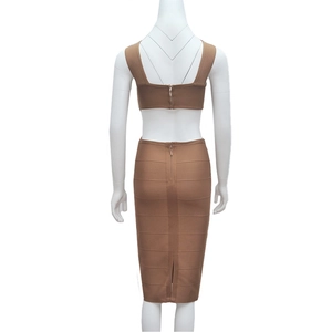 Detail of a brown ribbed bandage dress with back zipper and small slit on a mannequin