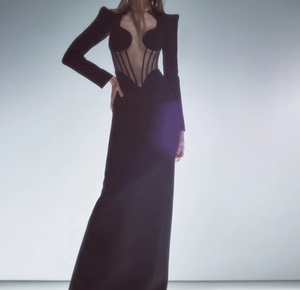 Detail of sheer mesh corset with vertical boning on a black long sleeve evening gown