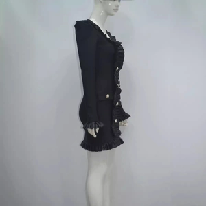 Black long sleeve mini dress with ruffled trim and decorative gold buttons
